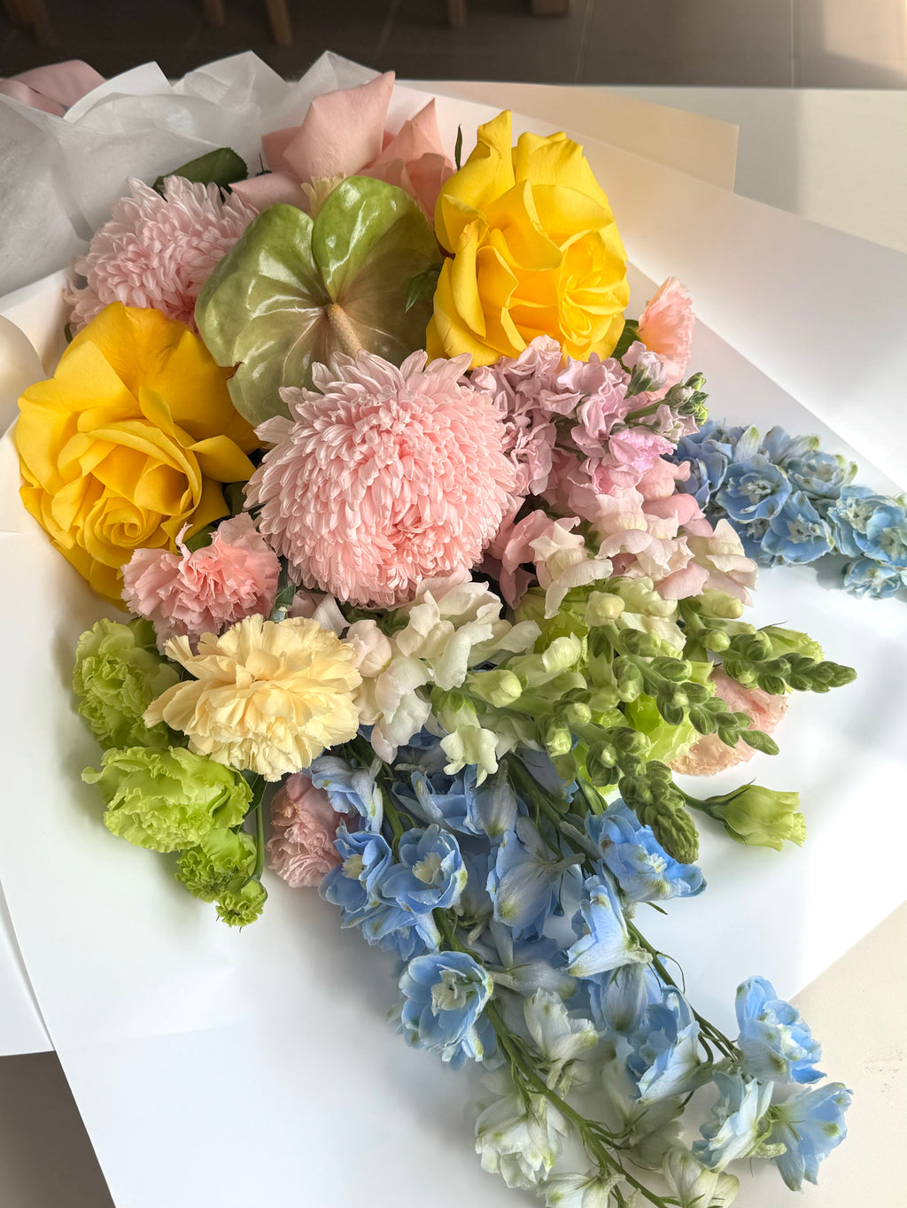 Colorful bouquet of flowers including yellow, pink, green, and blue